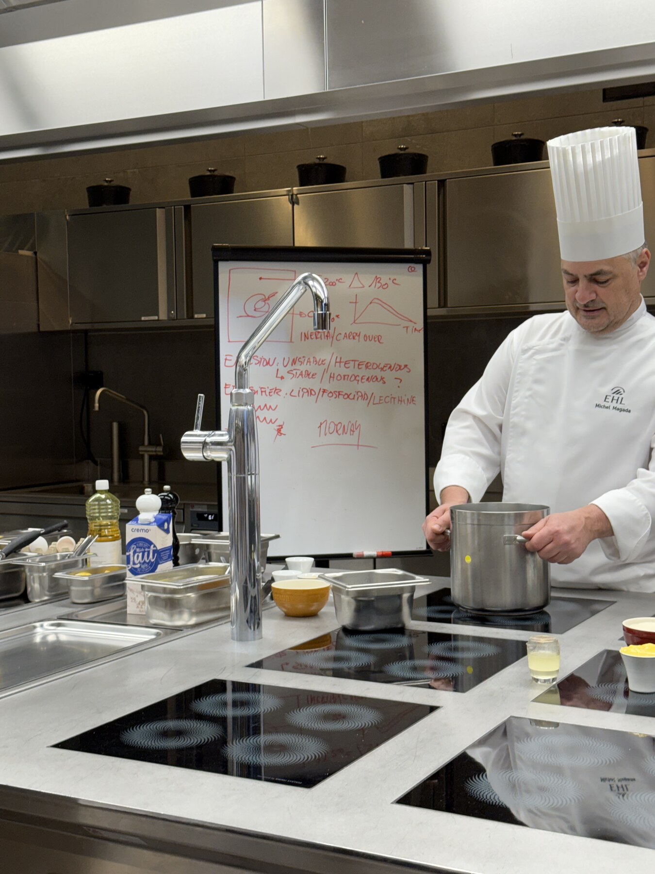 An EHL chef demonstrating techniques in the teaching kitchen